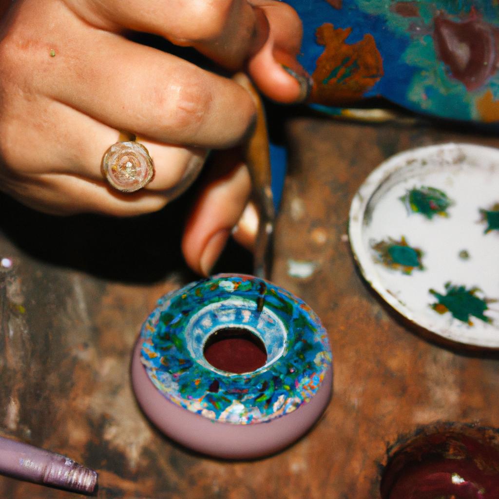 Woman creating intricate enamel designs